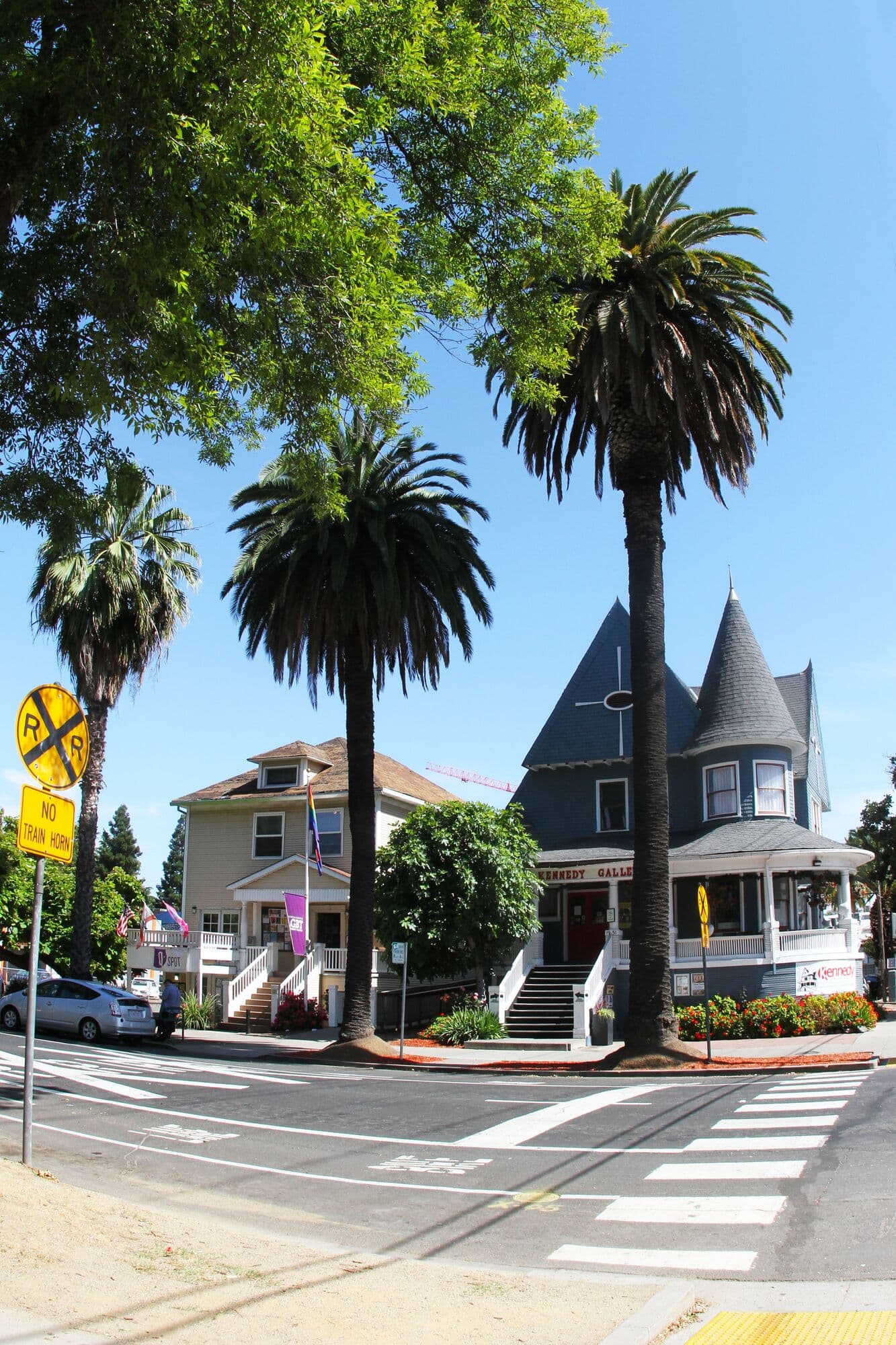 A turreted Victorian on a palm-lined corner in Midtown