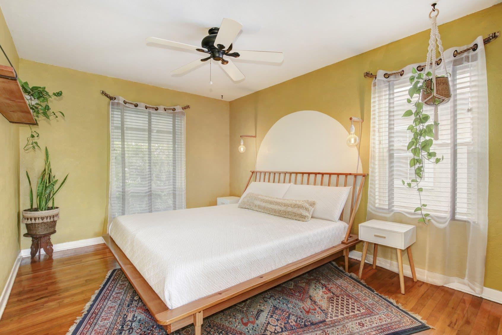 A sunny bedroom with warm yellow walls